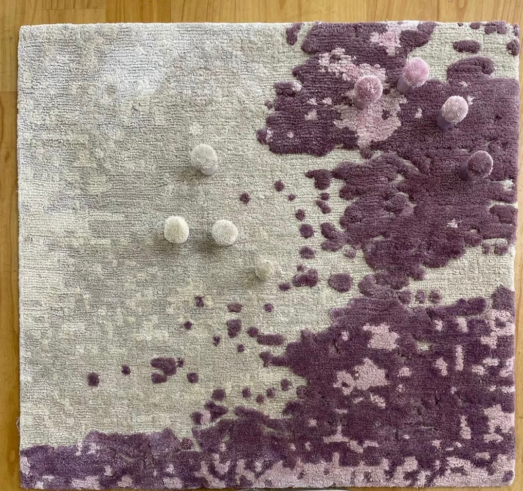 Square strike-off sample in ivory and violet with colour poms placed on each shade